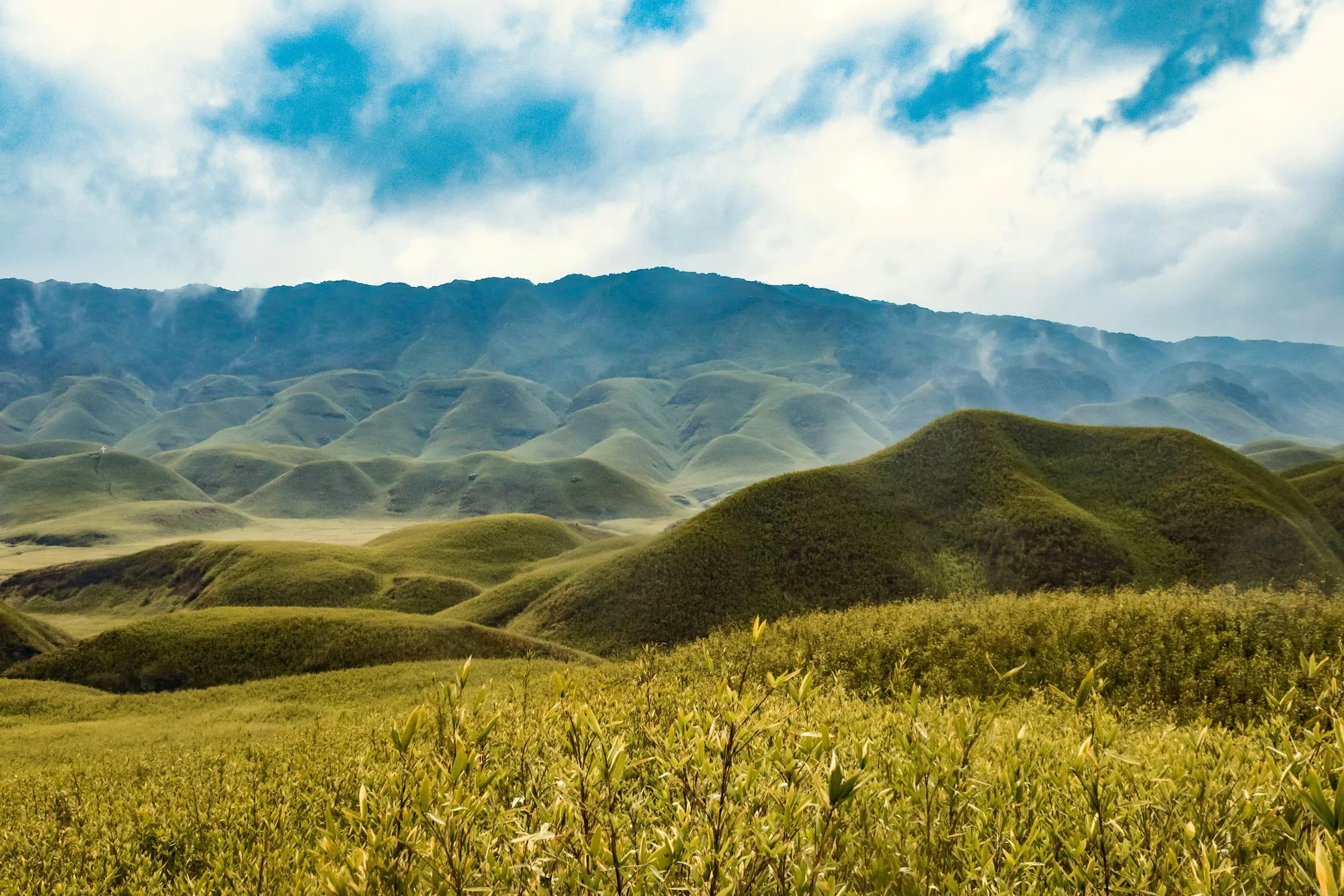 Rolling green valleys and distant mountain ridges